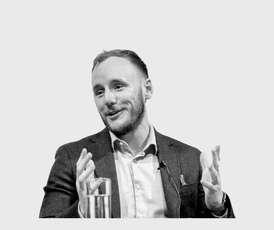 A photo of a male speaking and illustrating with his hands