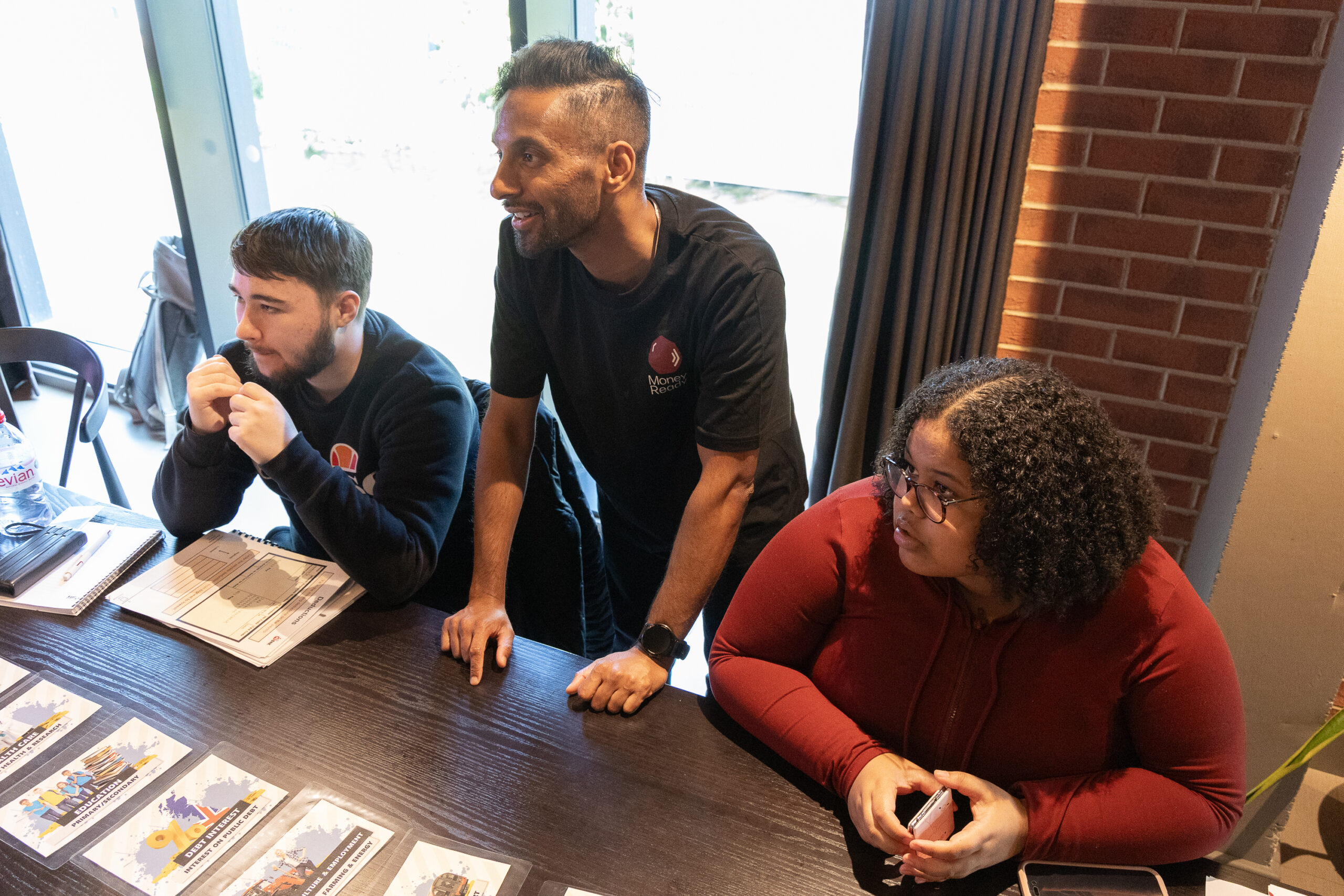 A picture of a lady wearing a red shirt and two men