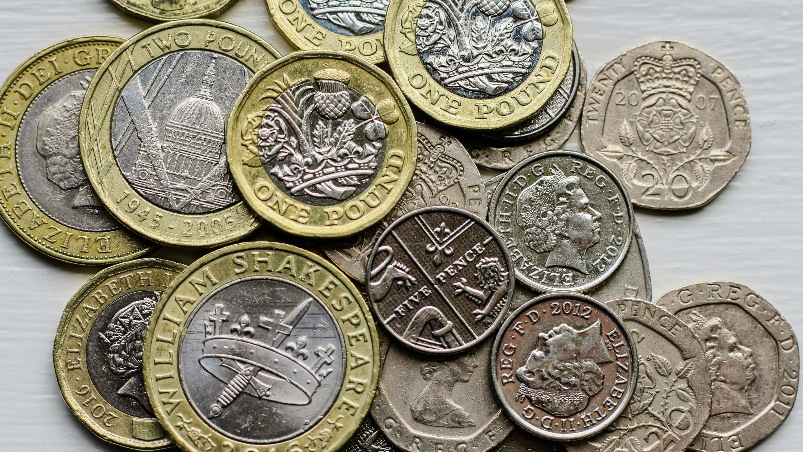 Pile of pound coins and silver coins