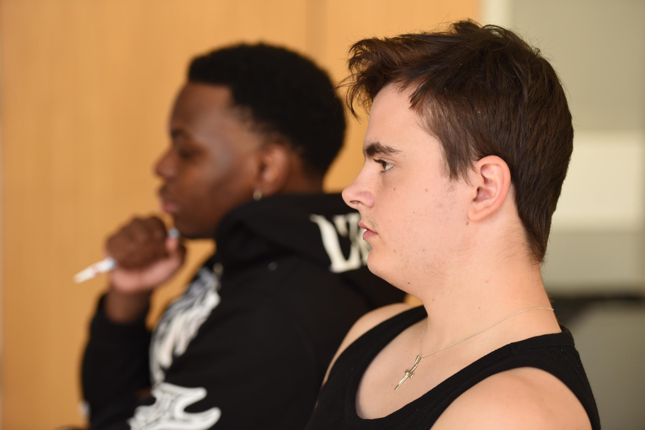 close up of two teenage boys in a classroom