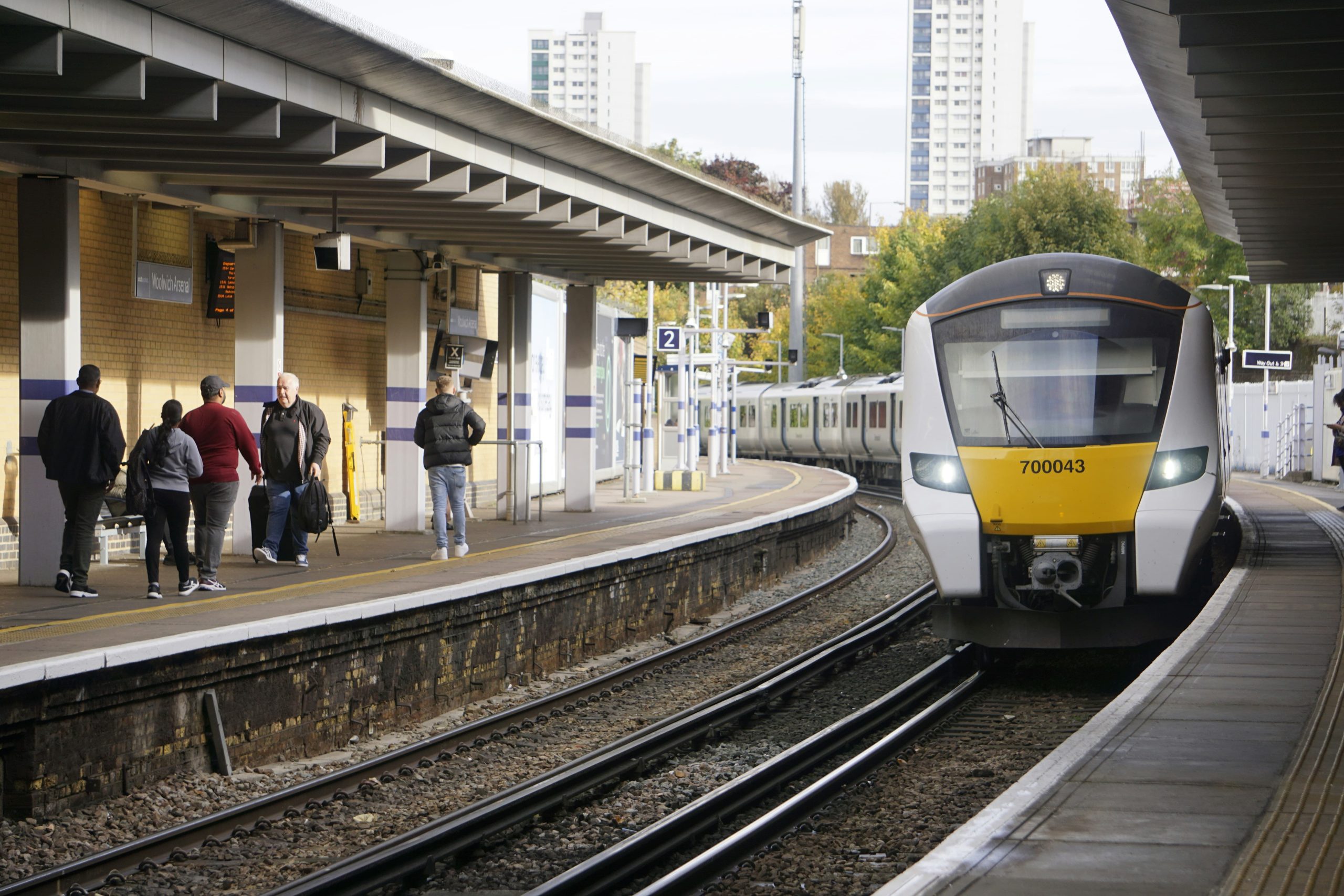 Train station platform with passengers on one side and a train on the other