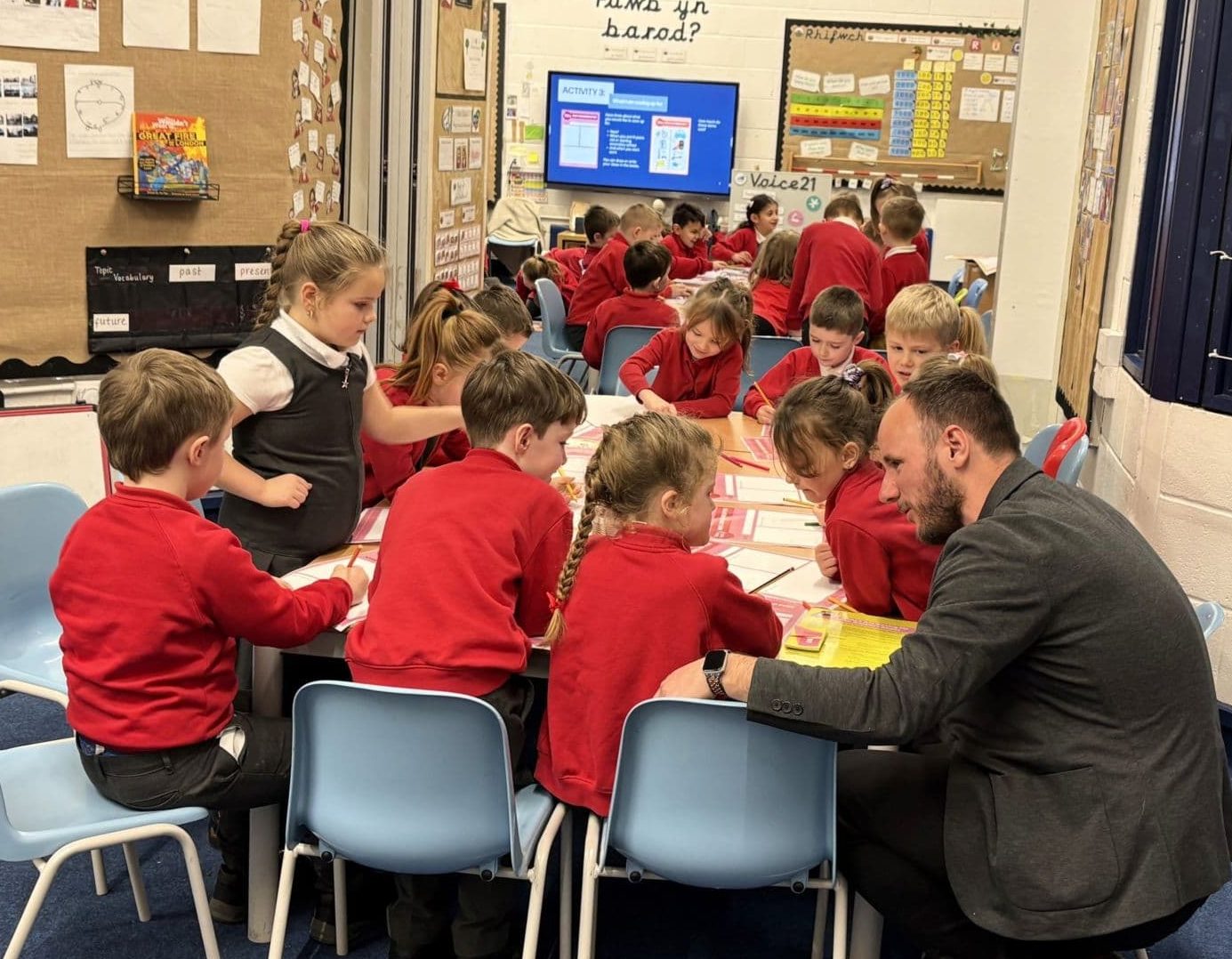 Leon Ward, CEO at Money Ready, volunteering with children in a primary school classroom in Wales