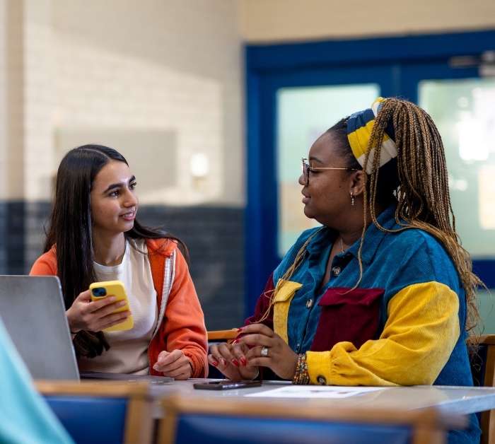Two young people talking in a financial education session.