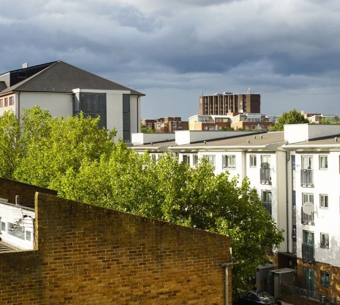 Grey cloudy sky over urban housing in the UK.